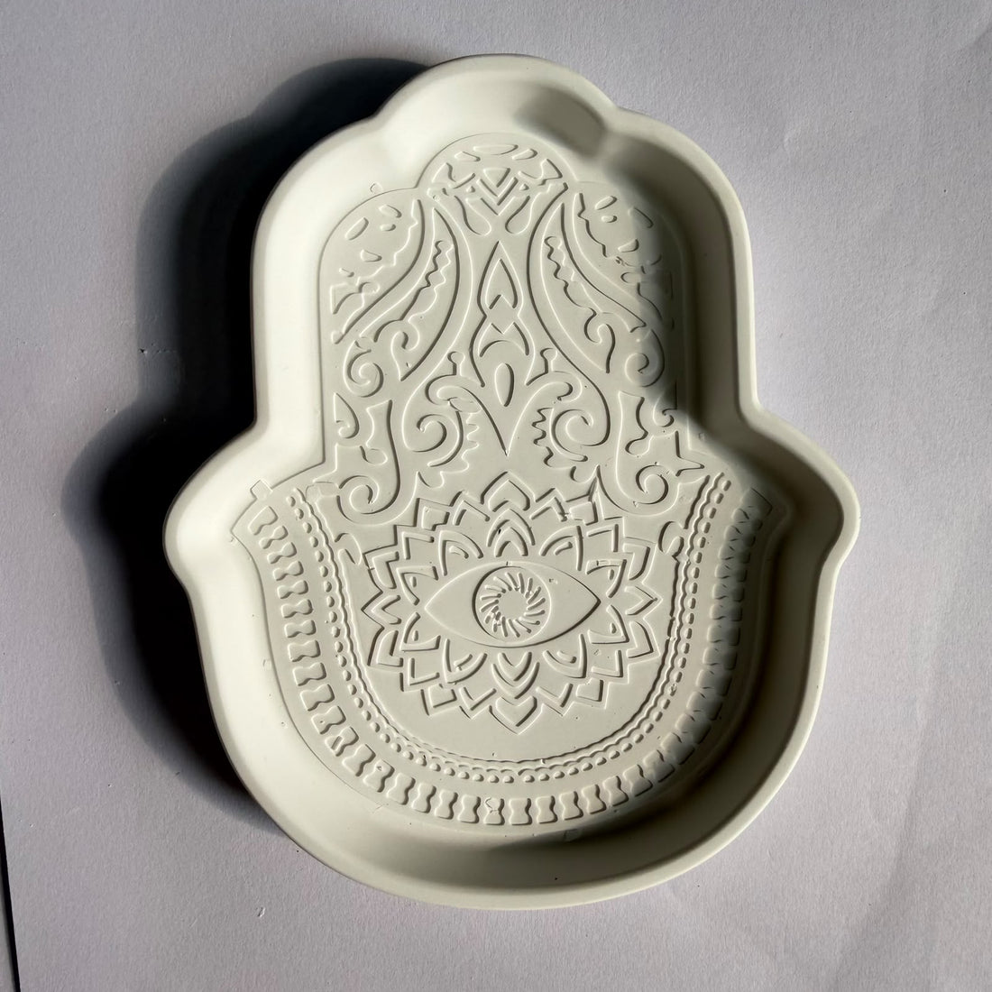 Hamsa concrete plate
