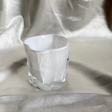 Uneven white candle glass